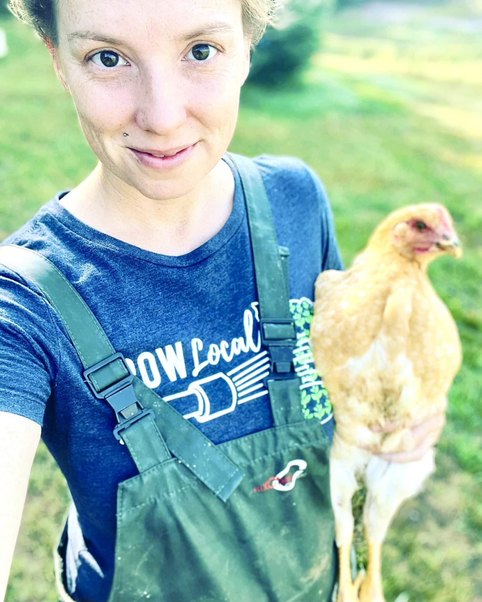 A selfie of Kelsey Zaavedra holding a chicken.